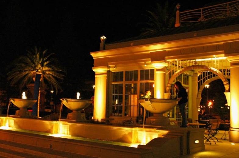 a man standing outside a home lit with candles