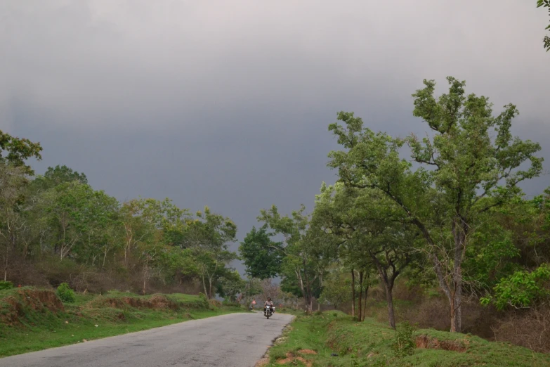 motorcycles are riding down a road on the other side