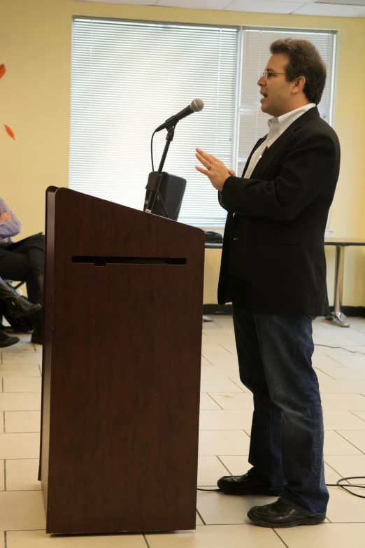 a man standing at a podium and giving a speech