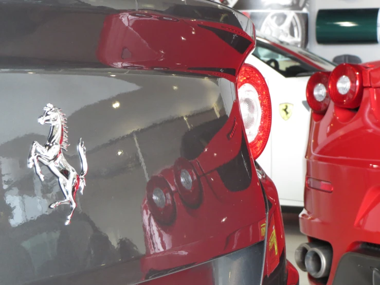 the rear end of a red ferrari sports car in a showroom