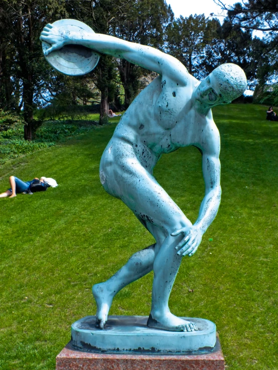 a blue marble statue of a man with his hand on his hips