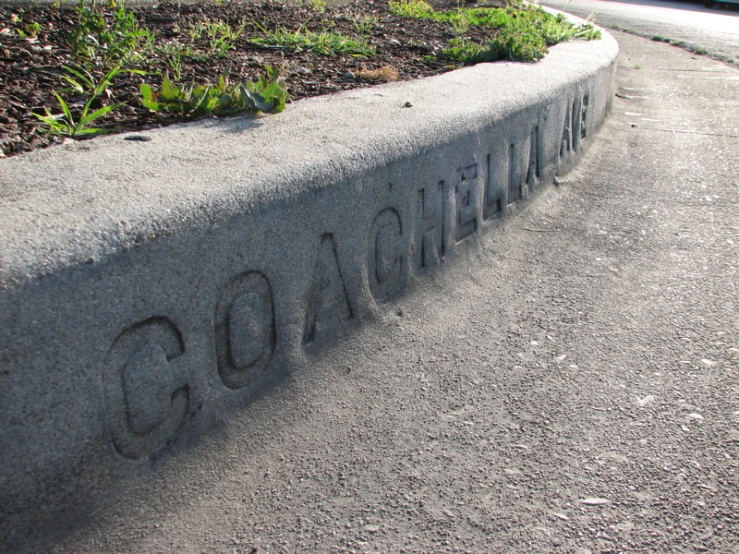 a concrete bench has writing on it
