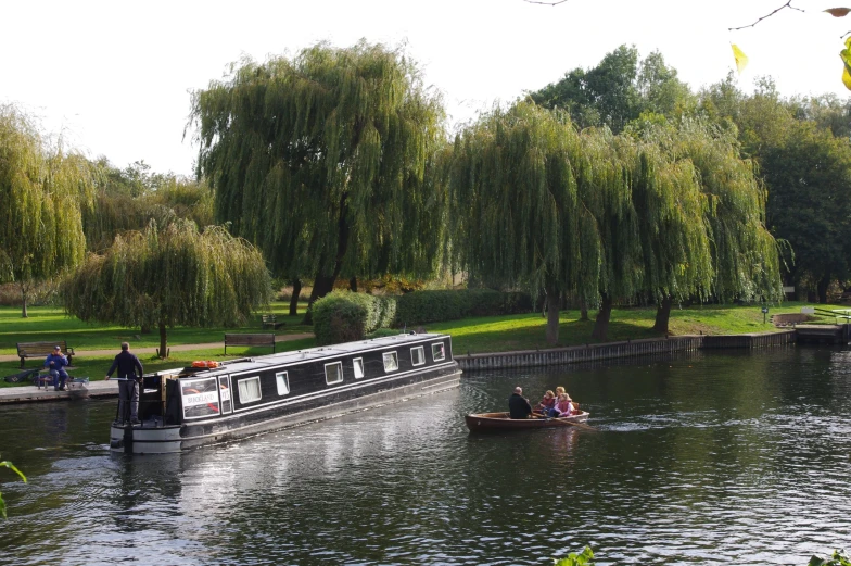 there are two people in a small boat going down a river