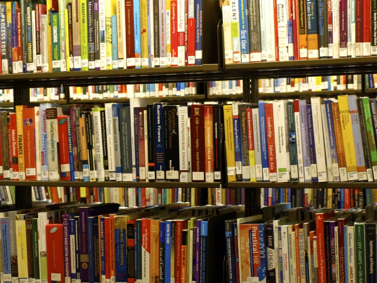 a wall full of books are covered by colorful covers