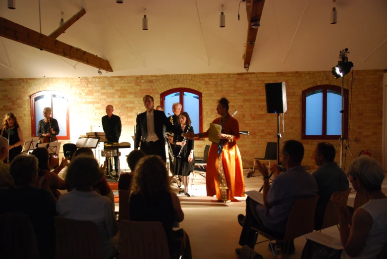 a group of people standing in front of an audience