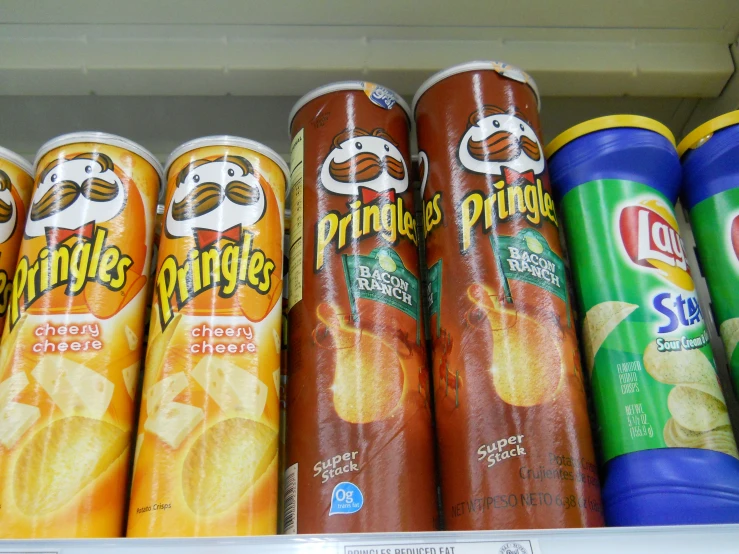 many different cans of chips in a display