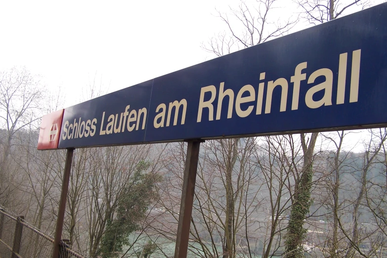 a sign pointing to a location in a forest