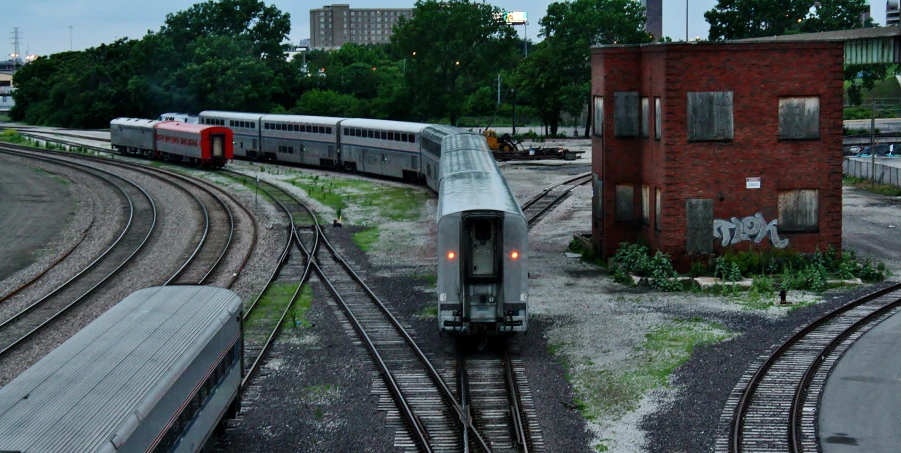 two trains and some buildings on train tracks