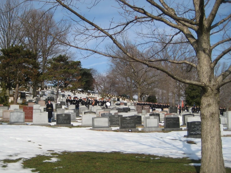 snow covers the ground around a headstone