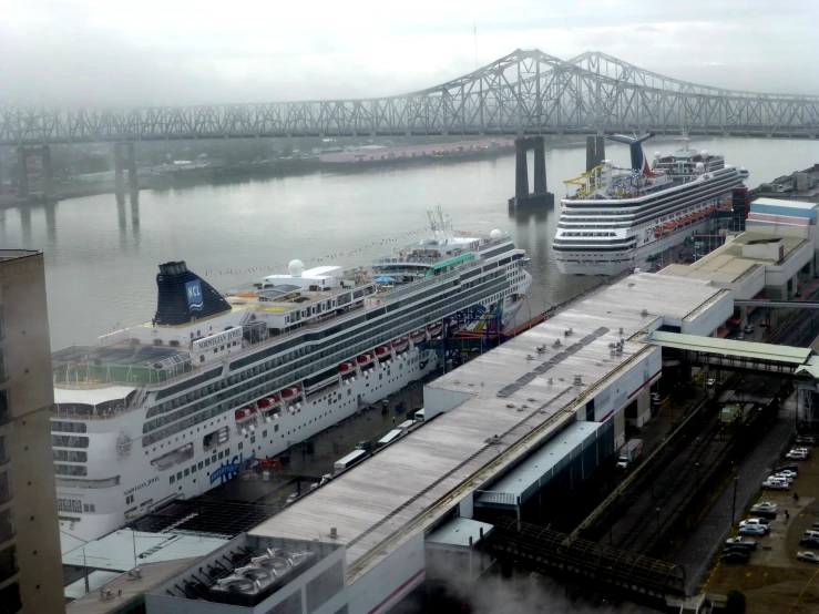 two large cruise ships sitting side by side