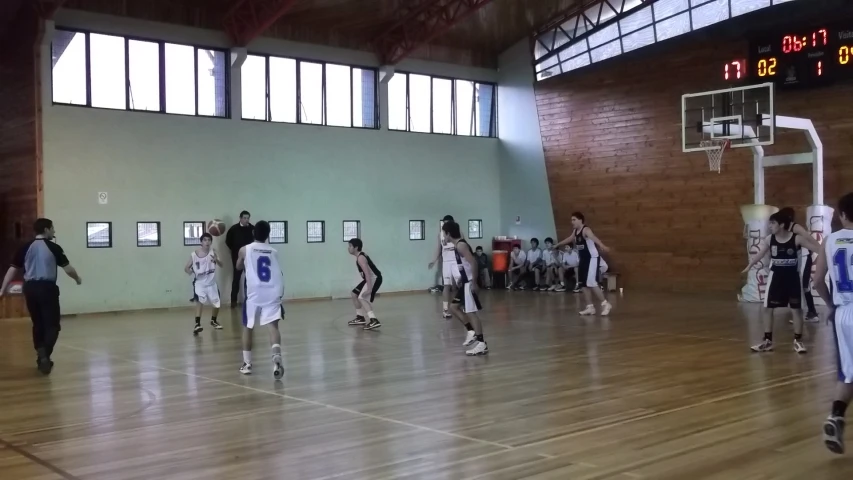 a group of young men playing a game of basketball