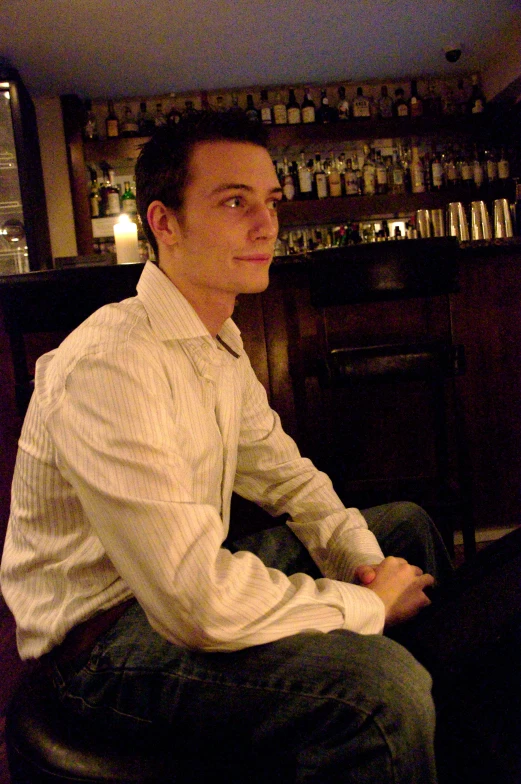 a man sitting in front of a bar