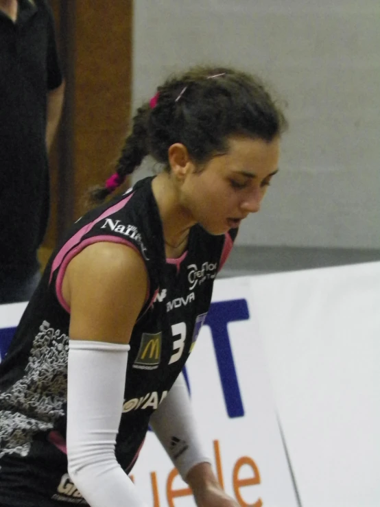 a woman with a racket prepares to throw the ball