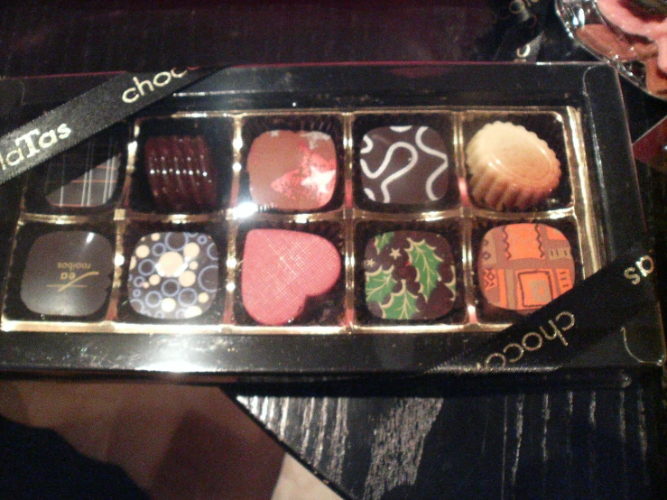 a table that has several chocolates in a box on it