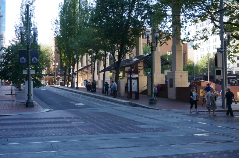 a city street with people walking down the middle