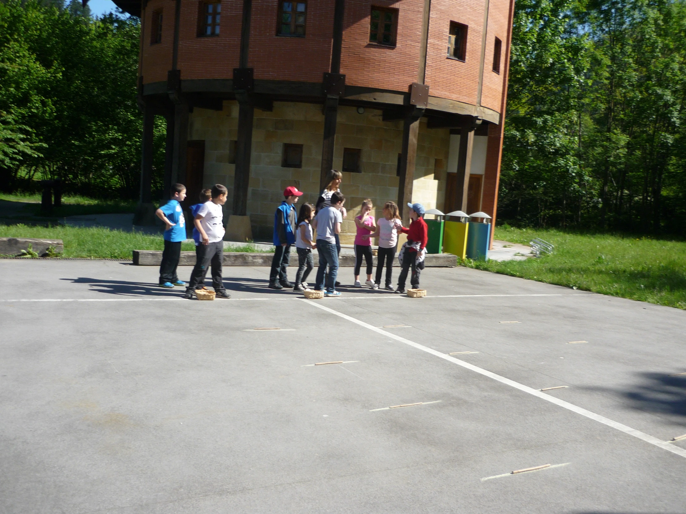 small s are on a paved surface near a building