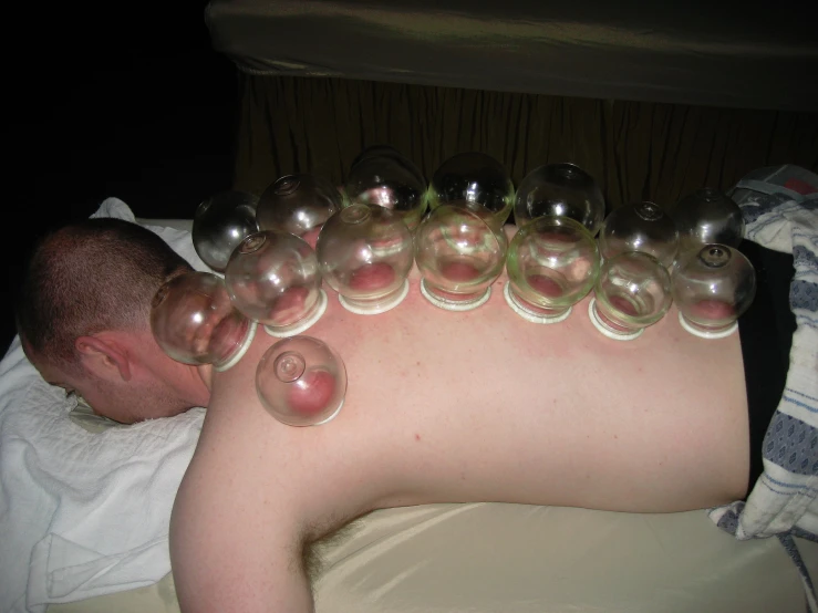 a man lies on his stomach with a lot of bubble like items