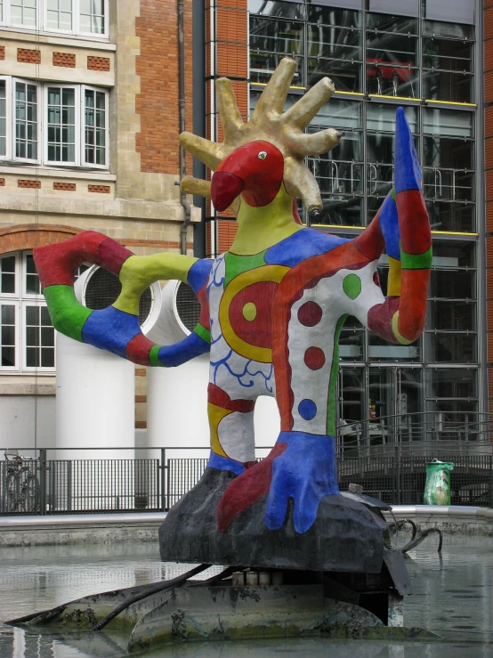 a multicolored sculpture of a giraffe with many circles on it