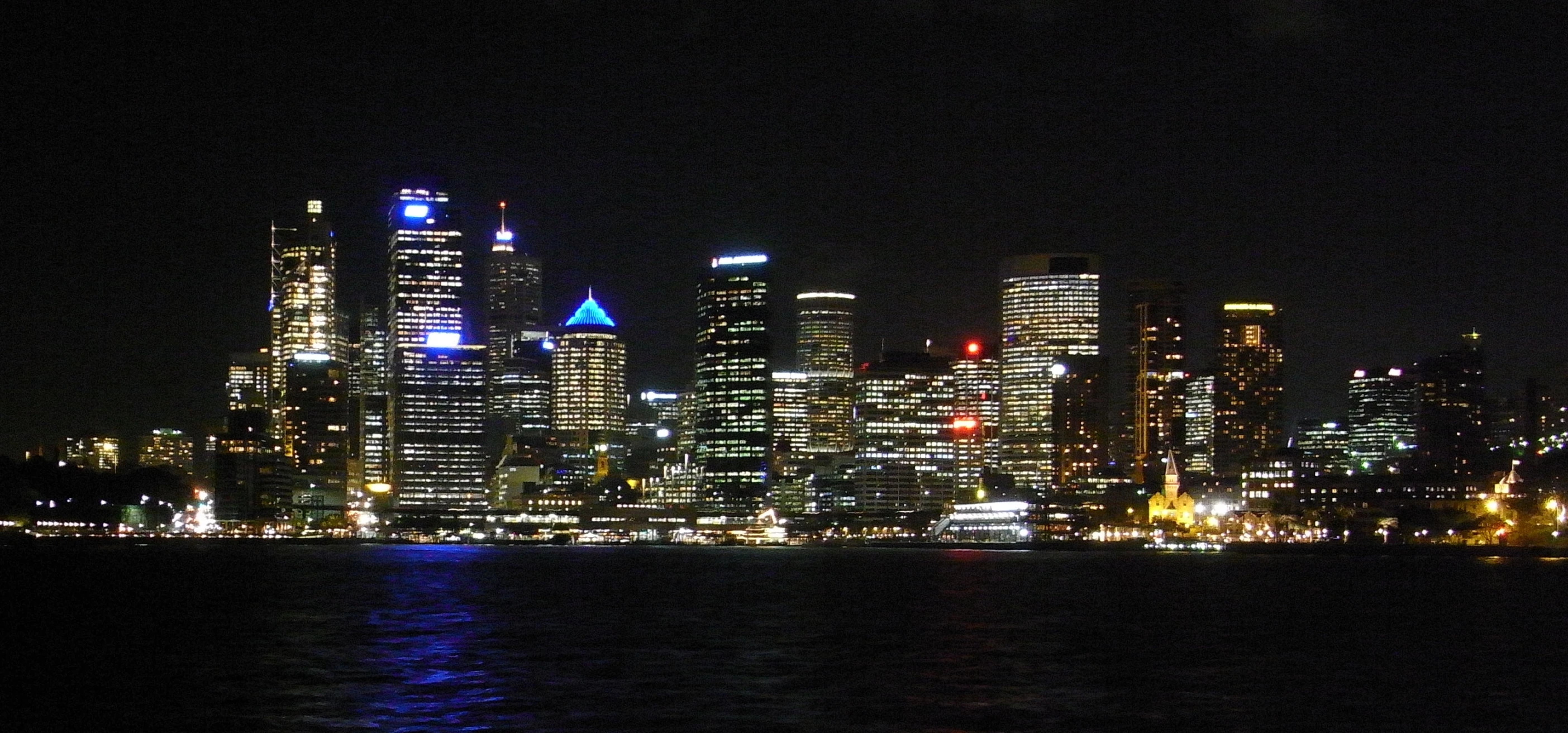 a picture of the lights of many city buildings on a dark night