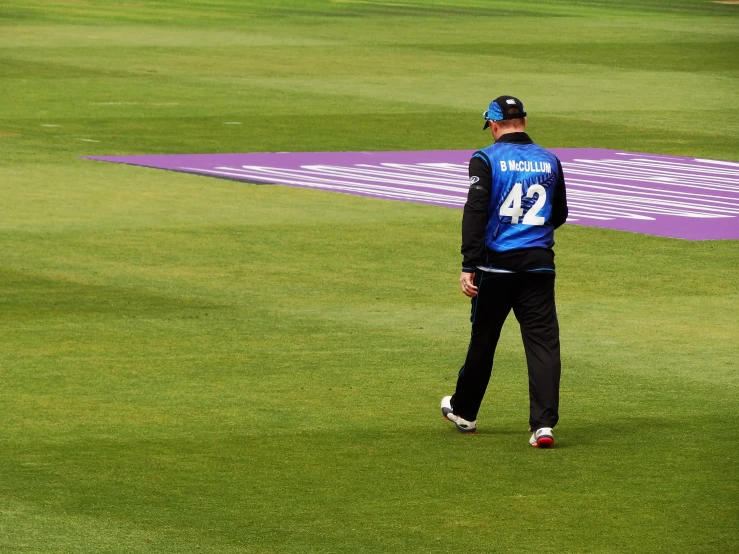 the male cricket player looks on during practice