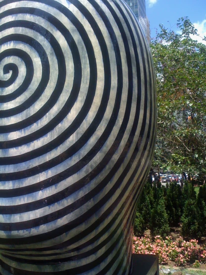 a spiraled sculpture is shown on the ground