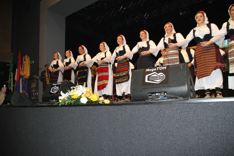 the six people are dressed in traditional polish clothing