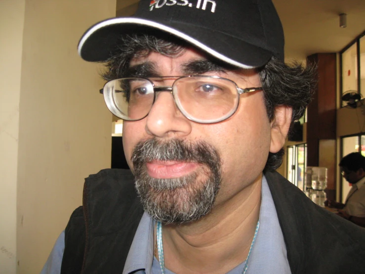 a man with glasses and a hat on