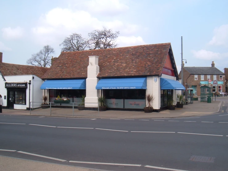 a blue awning on top of a building next to a street