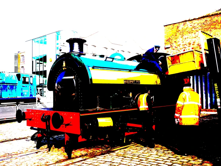 a black and yellow train engine on tracks