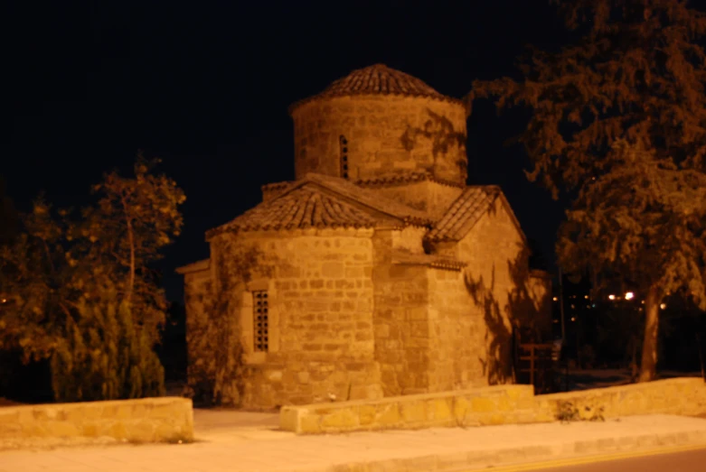 an old and damaged tower house with it's lights on