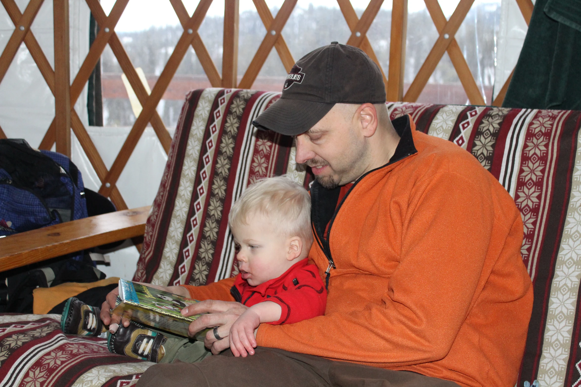 a man sitting on a couch with a child