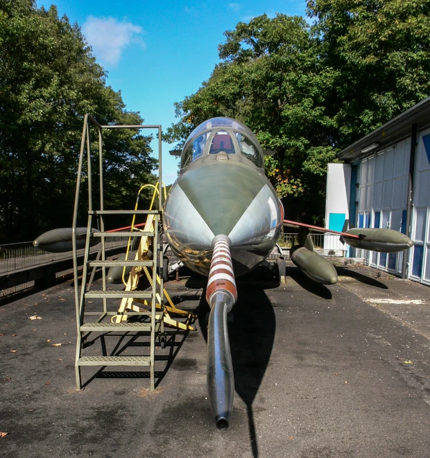 a military jet parked in a hanger on the ground