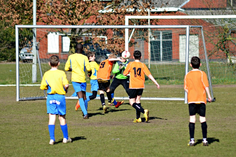 a group of young men playing soccer against each other