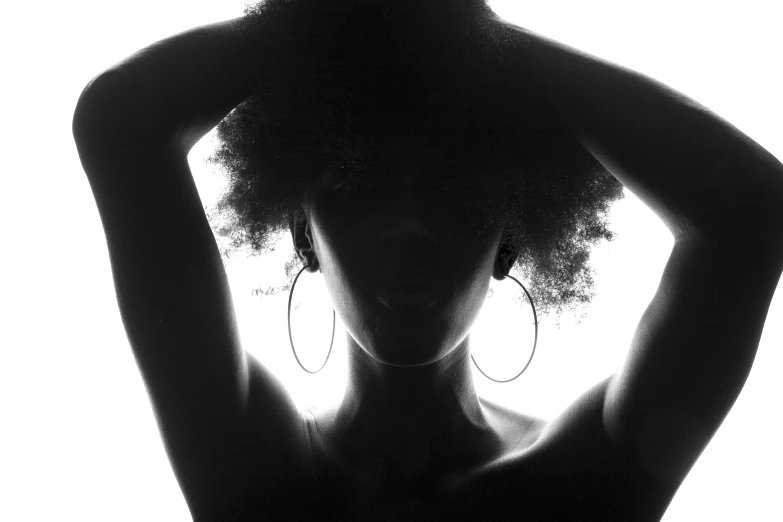 a woman's silhouette, with a hoop earrings
