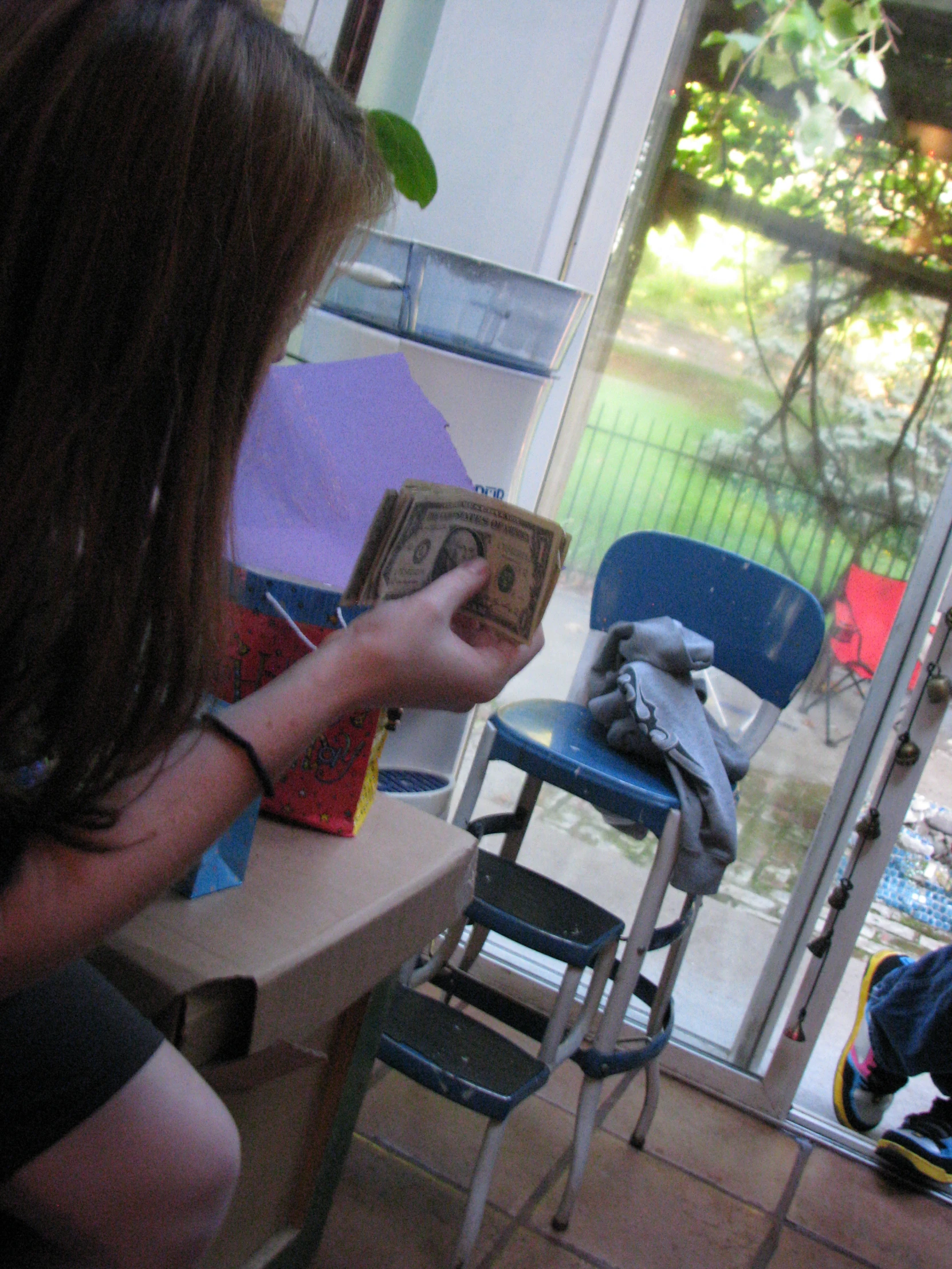 the young person is holding a box near the chair