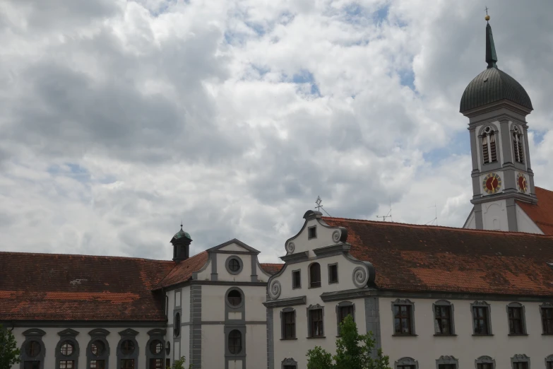 a building with an ornate roof with a clock tower and a steeple