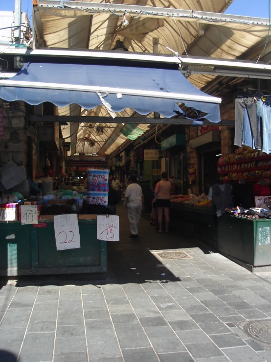 a street market with an open air market and people looking at things