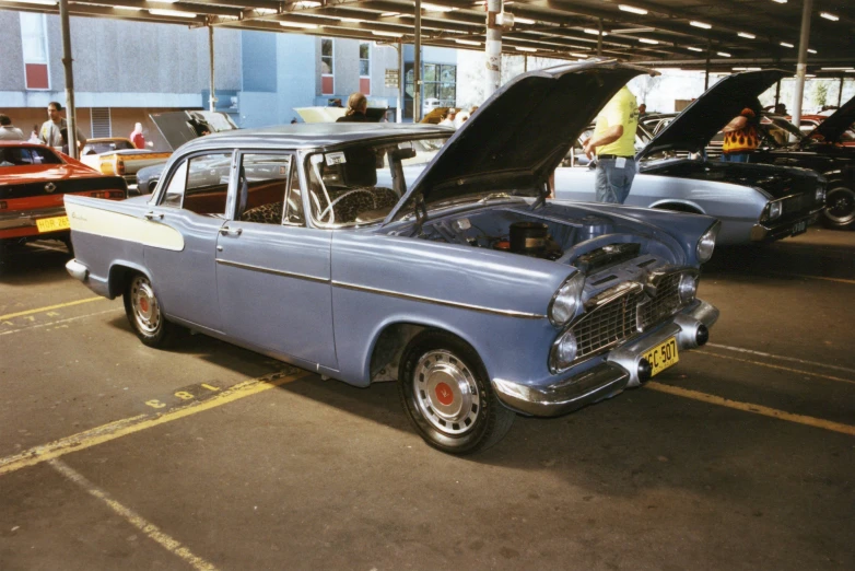 the old cars are parked in the parking lot