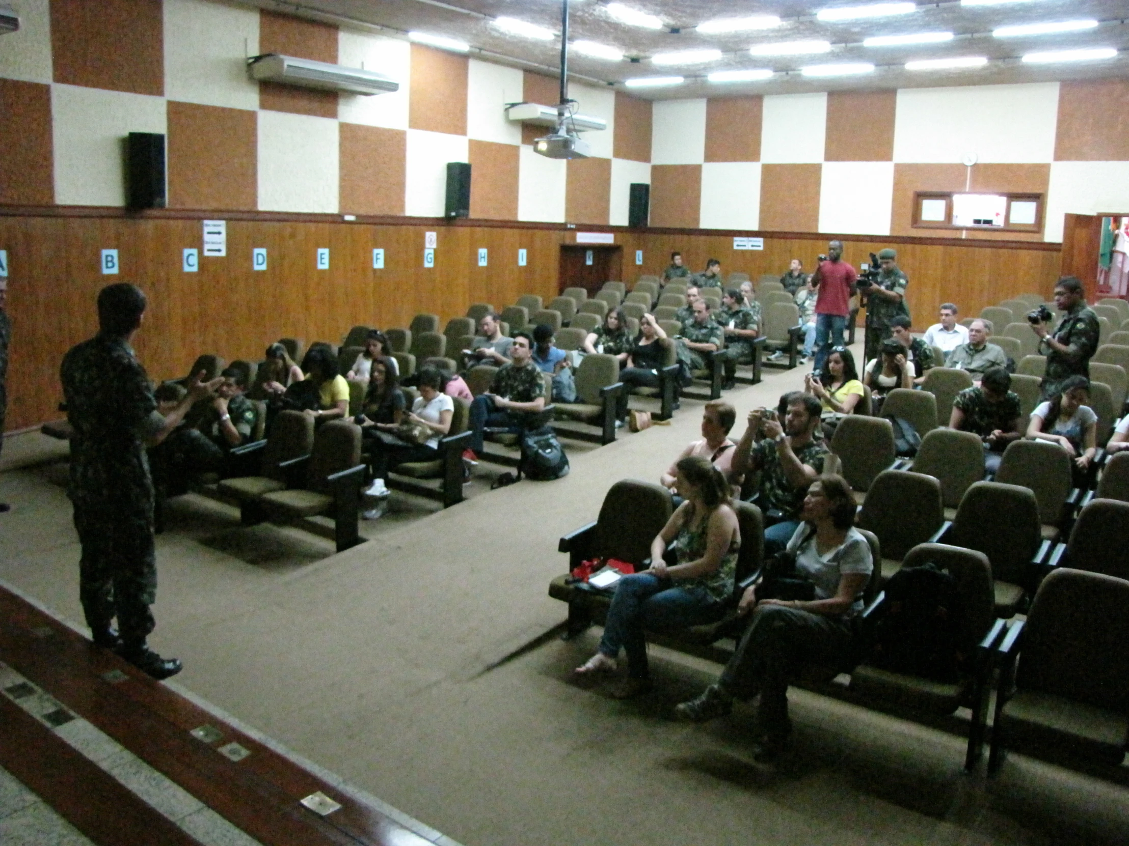 a room full of people sitting down in chairs