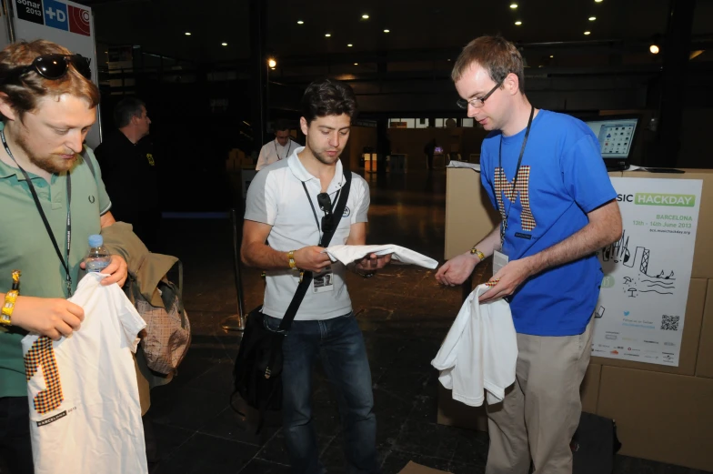 two men wearing neck ties look at a newspaper