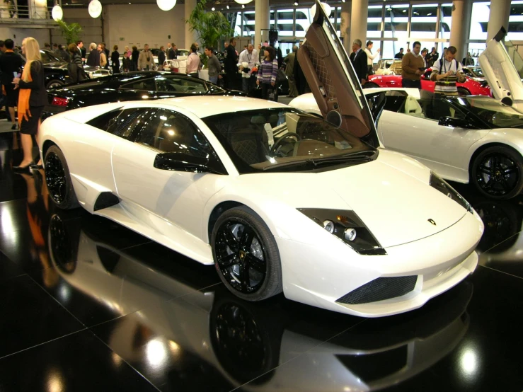 a very fancy looking sports car parked inside of a building