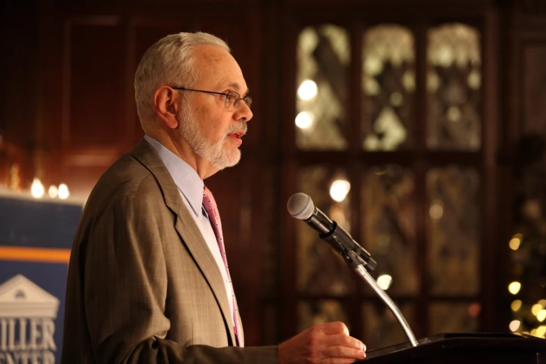 man giving a speech in front of a large audience