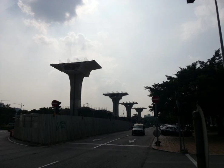 a bunch of tall towers on the side of a road