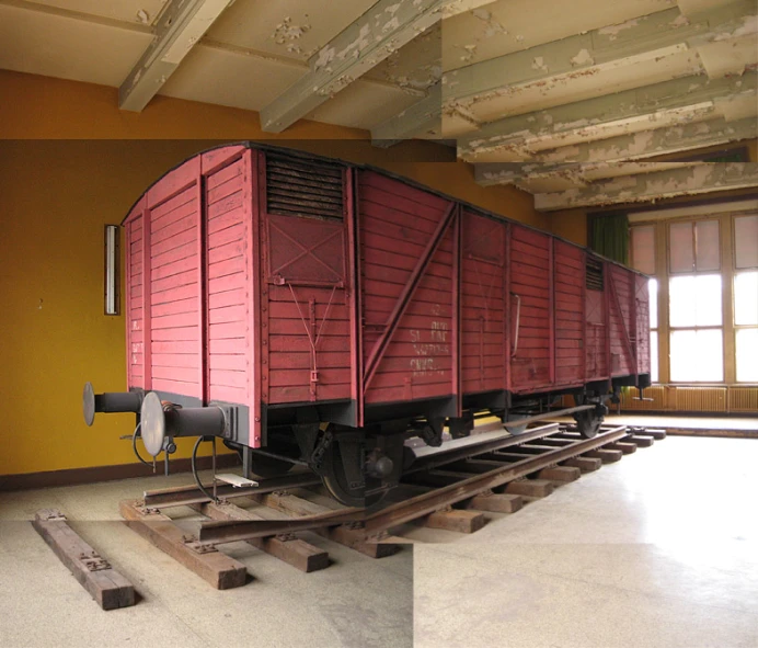 a train car sitting on railroad tracks with other pieces of machinery around it