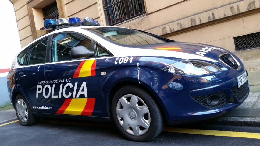 police car with flags on it parked on the side of a building
