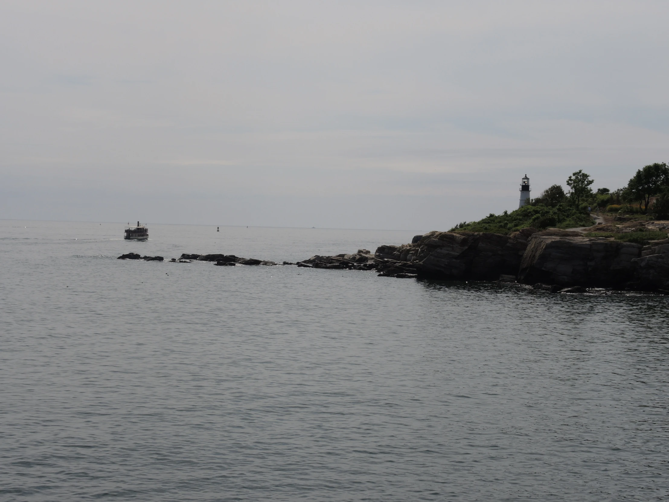 the lighthouse is on the cliff above the ocean