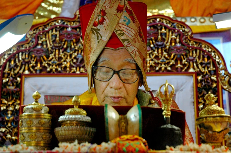 a man wearing glasses with head covering and glasses