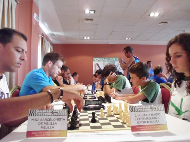 a group of people playing chess inside a building