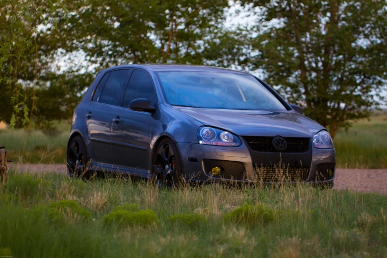 a volkswagen golf wagon parked on a dirt road
