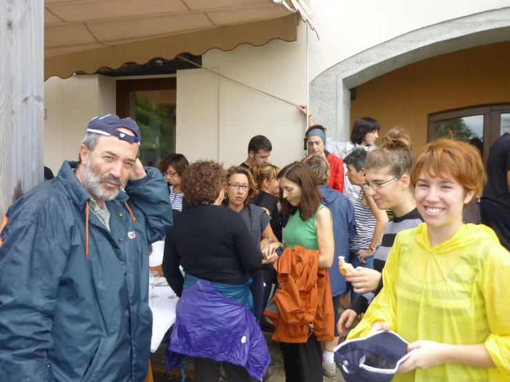 a large group of people gather outside of a building